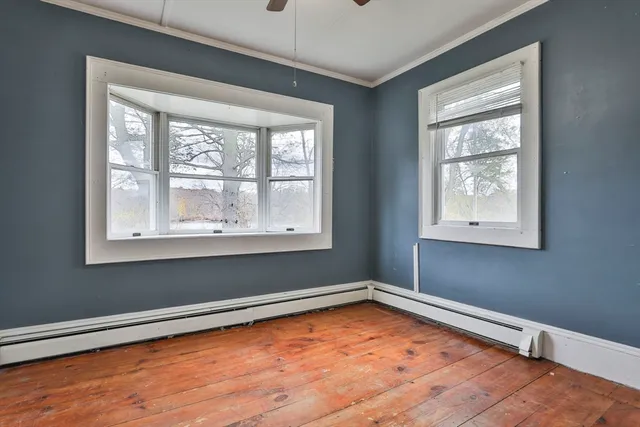 a view of a room with rack on the wall and a window