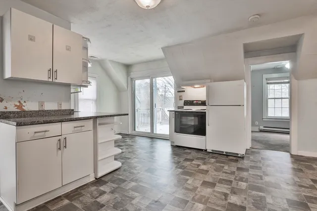 an empty room with windows and entrance