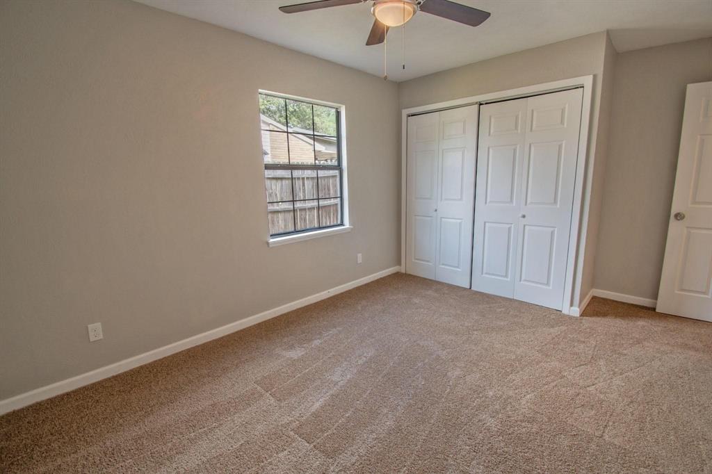 3825 Hackberry Lane Bedford, TX 76021 - Photo 11 of 24 an empty room with chandelier fan and windows