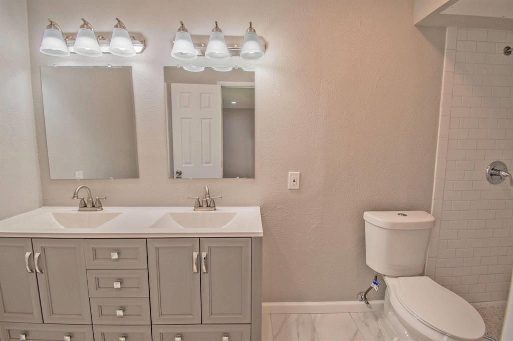 3825 Hackberry Lane Bedford, TX 76021 - Photo 16 of 24 a bathroom with a toilet sink and mirror