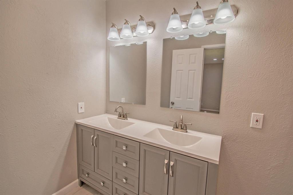 3825 Hackberry Lane Bedford, TX 76021 - Photo 17 of 24 a bathroom with a sink double vanity and a mirror