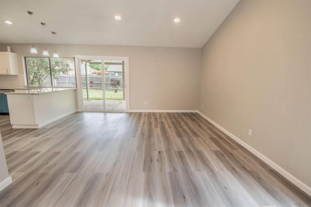 3825 Hackberry Lane Bedford, TX 76021 - Photo 2 of 24 an empty room with wooden floor and windows