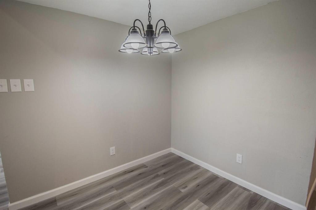 3825 Hackberry Lane Bedford, TX 76021 - Photo 7 of 24 a view of empty room with wooden floor