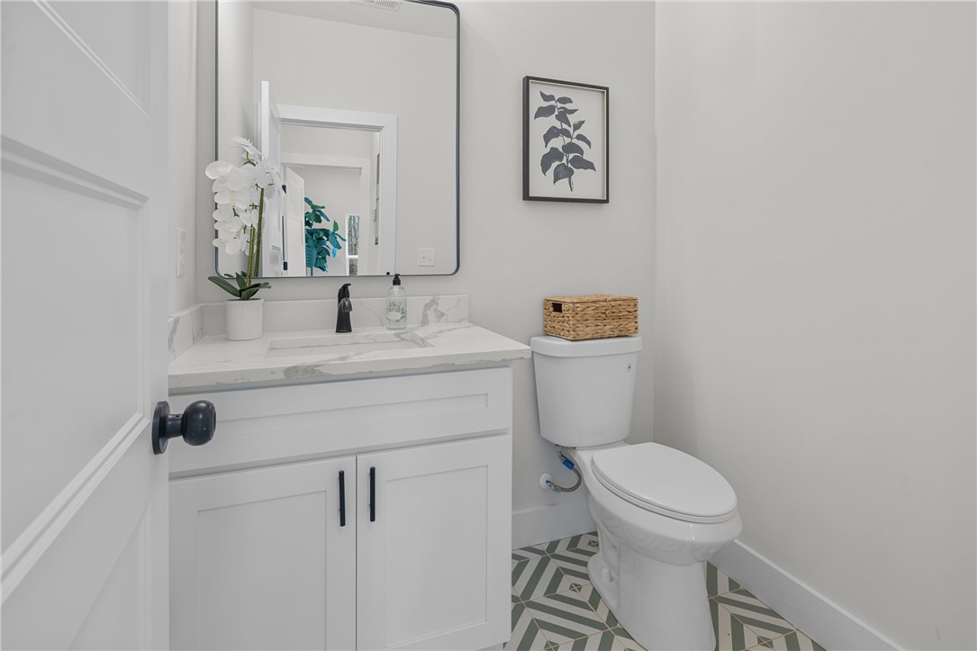 502 Point Road Westminster, SC 29693 - Photo 14 of 45 This bright guest bathroom offers a clean aesthetic with a modern vanity and elegant patterned flooring.