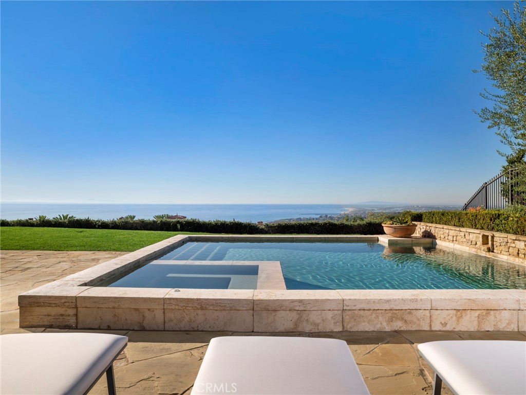 21 Shell Beach Newport Coast, CA 92657 - Photo 2 of 8 a view of swimming pool with lounge chair in front of house