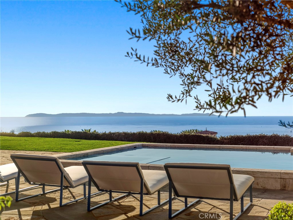 21 Shell Beach Newport Coast, CA 92657 - Photo 3 of 8 a view of a chairs and table in a lake