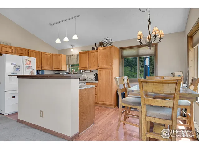 a dining room with furniture large windows and a chandelier