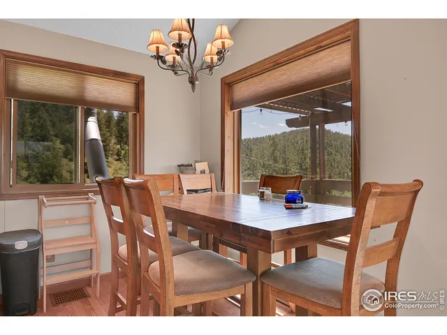 a spacious bedroom with a bed and a chandelier