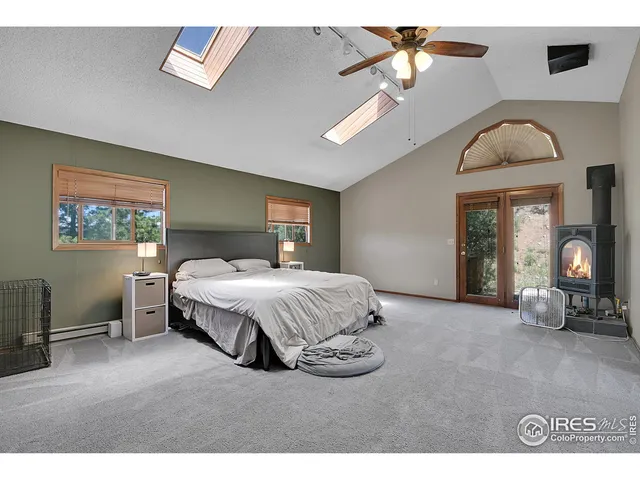 a spacious bedroom with a bed and a chandelier