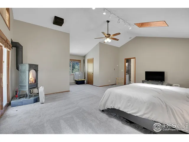 a bedroom with a bed and a flat tv screen on dresser