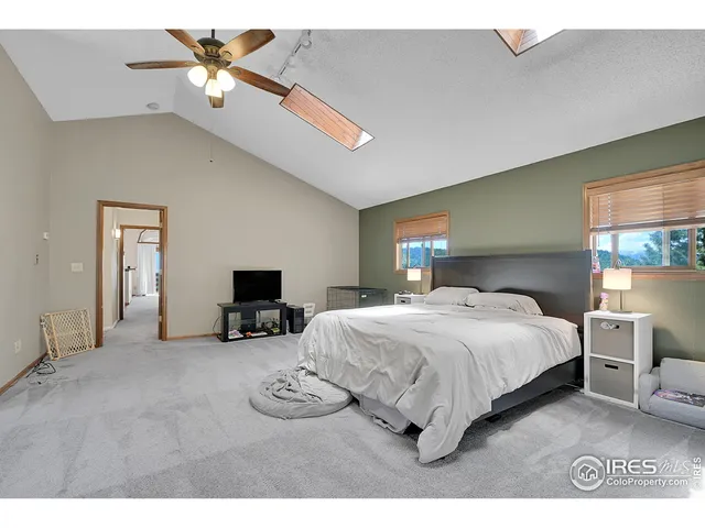 a spacious bedroom with a bed and a view of bedroom