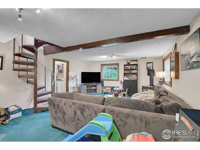 a bedroom with a bed and a view of living room