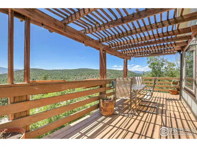 a view of a balcony with wooden floor and outdoor space