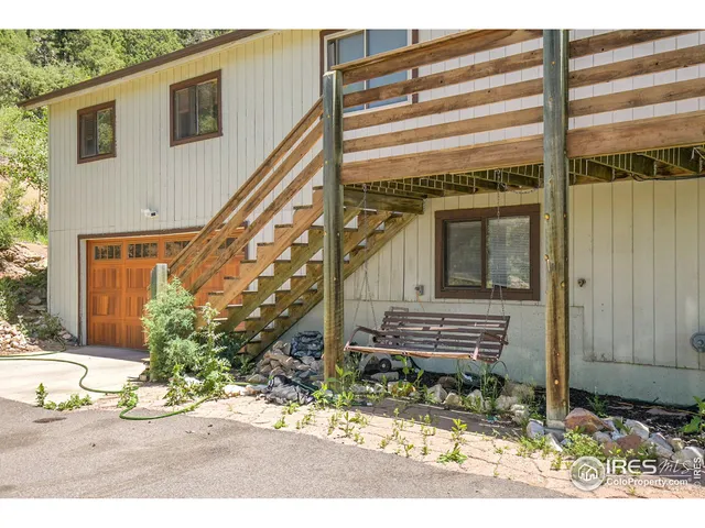 a living room with furniture a chandelier and a flat screen tv