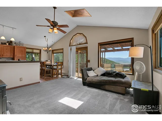 a view of a livingroom with furniture and a flat screen tv