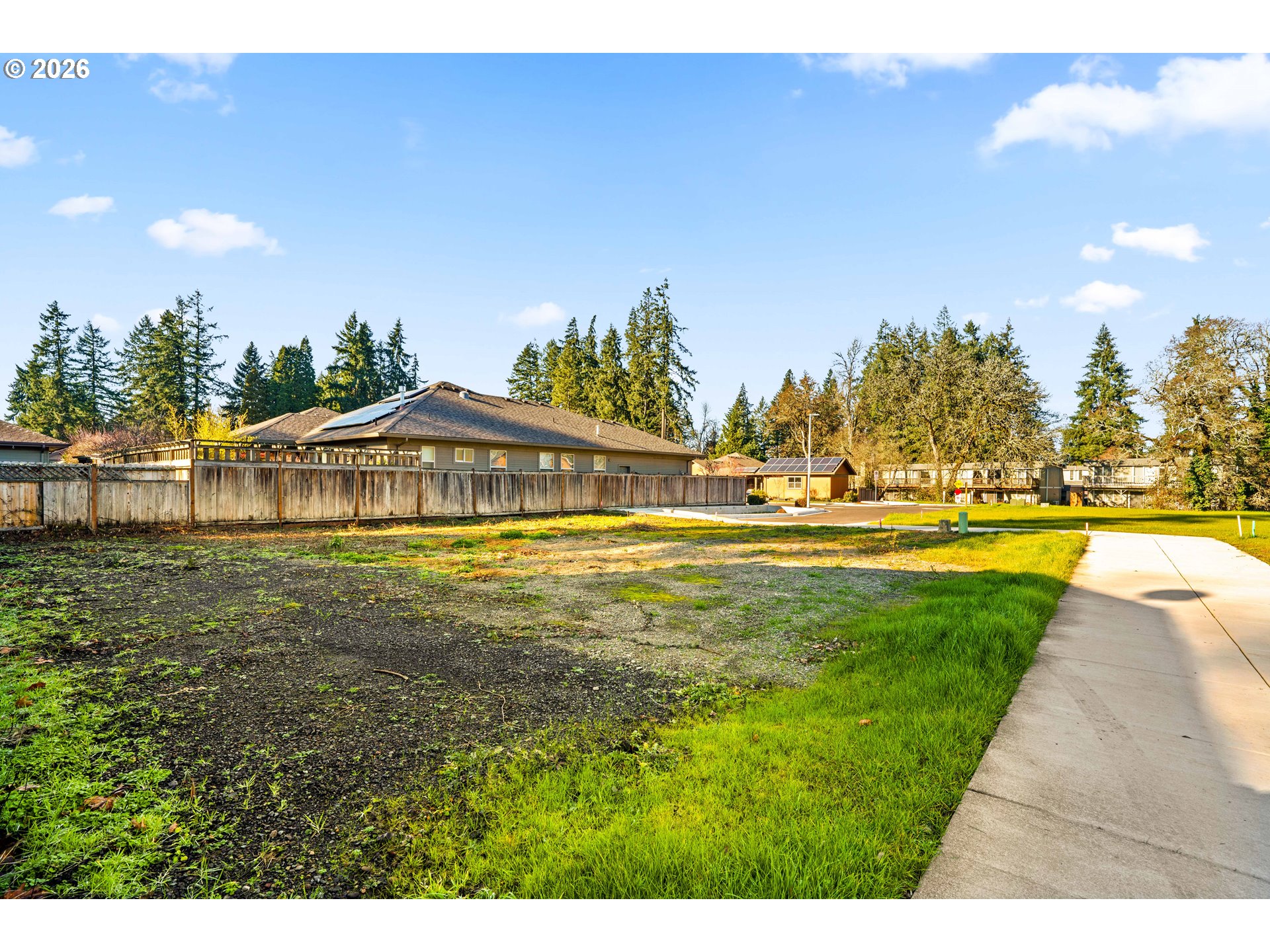 Piper Lane Eugene, OR 97401 - Photo 7 of 16 a view of swimming pool with outdoor seating and trees in the background