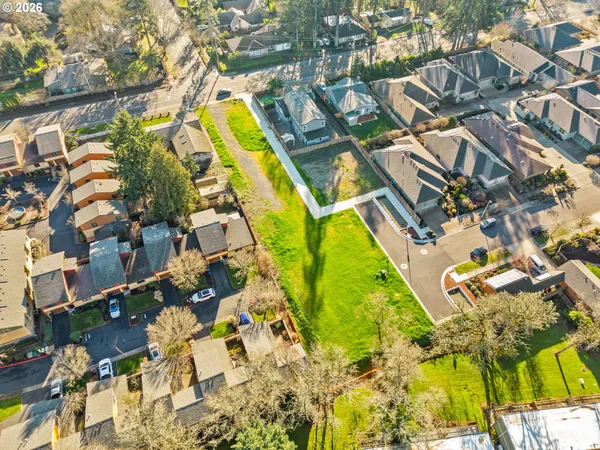 an aerial view of residential houses with yard