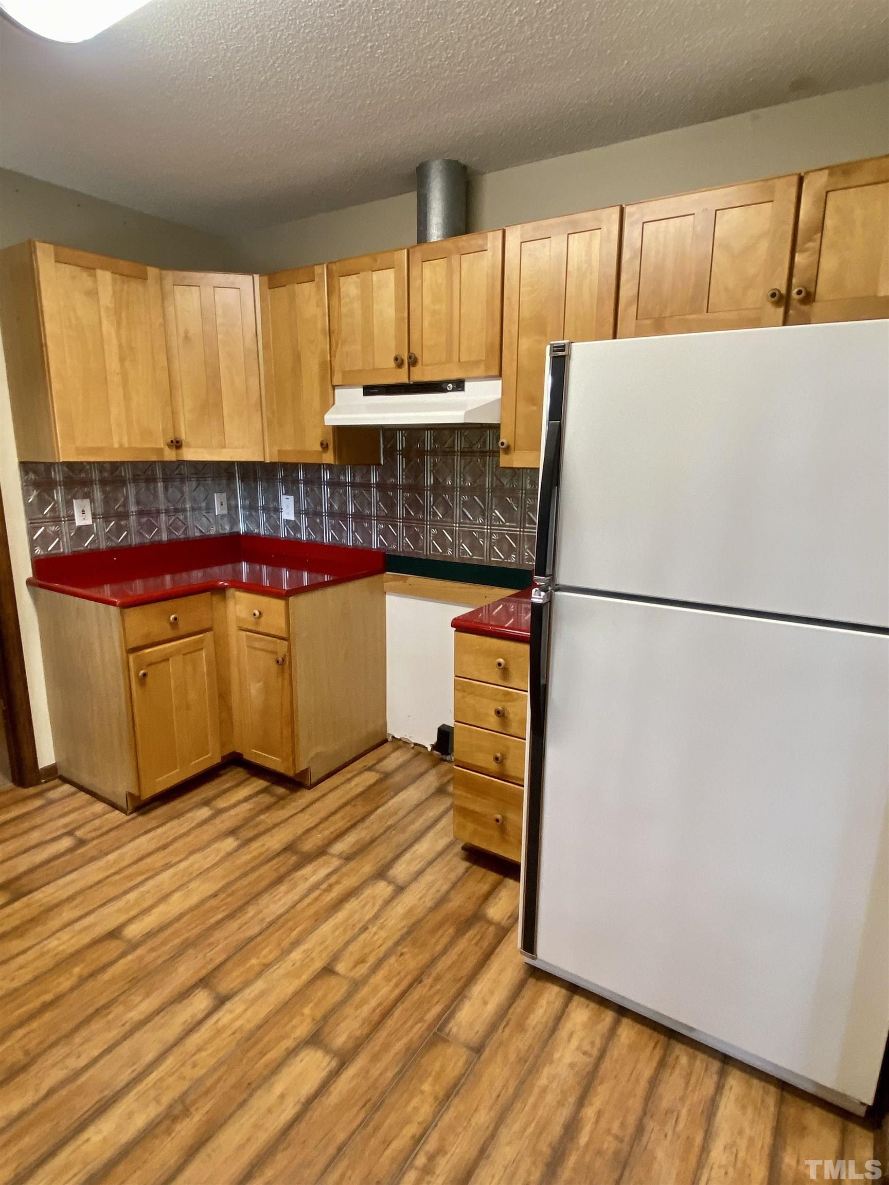 1887 Burnside Road Oxford, NC 27565 - Photo 12 of 42 a kitchen with stainless steel appliances granite countertop a refrigerator sink and wooden cabinets
