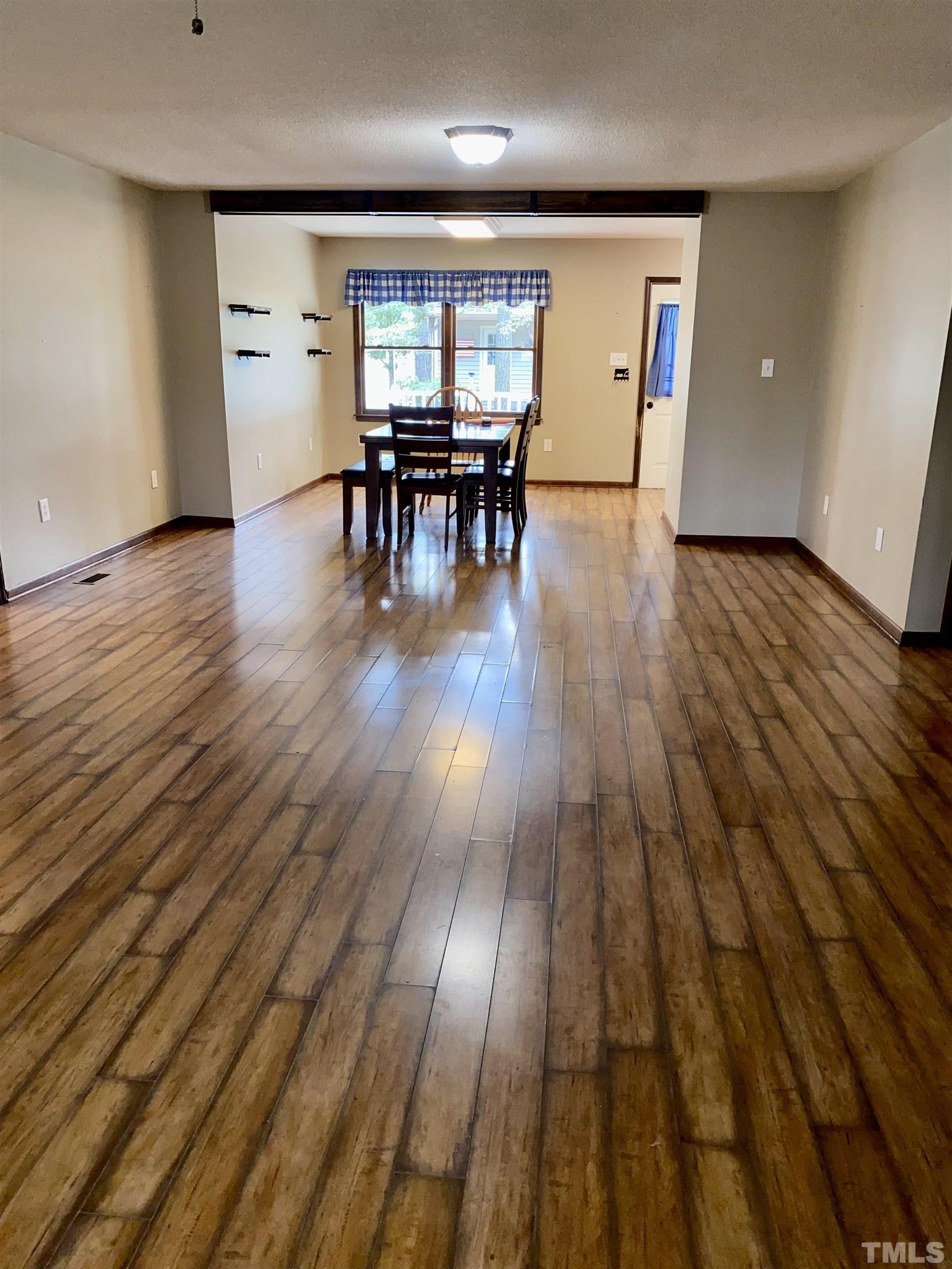 1887 Burnside Road Oxford, NC 27565 - Photo 14 of 42 an empty room with wooden floor and furniture
