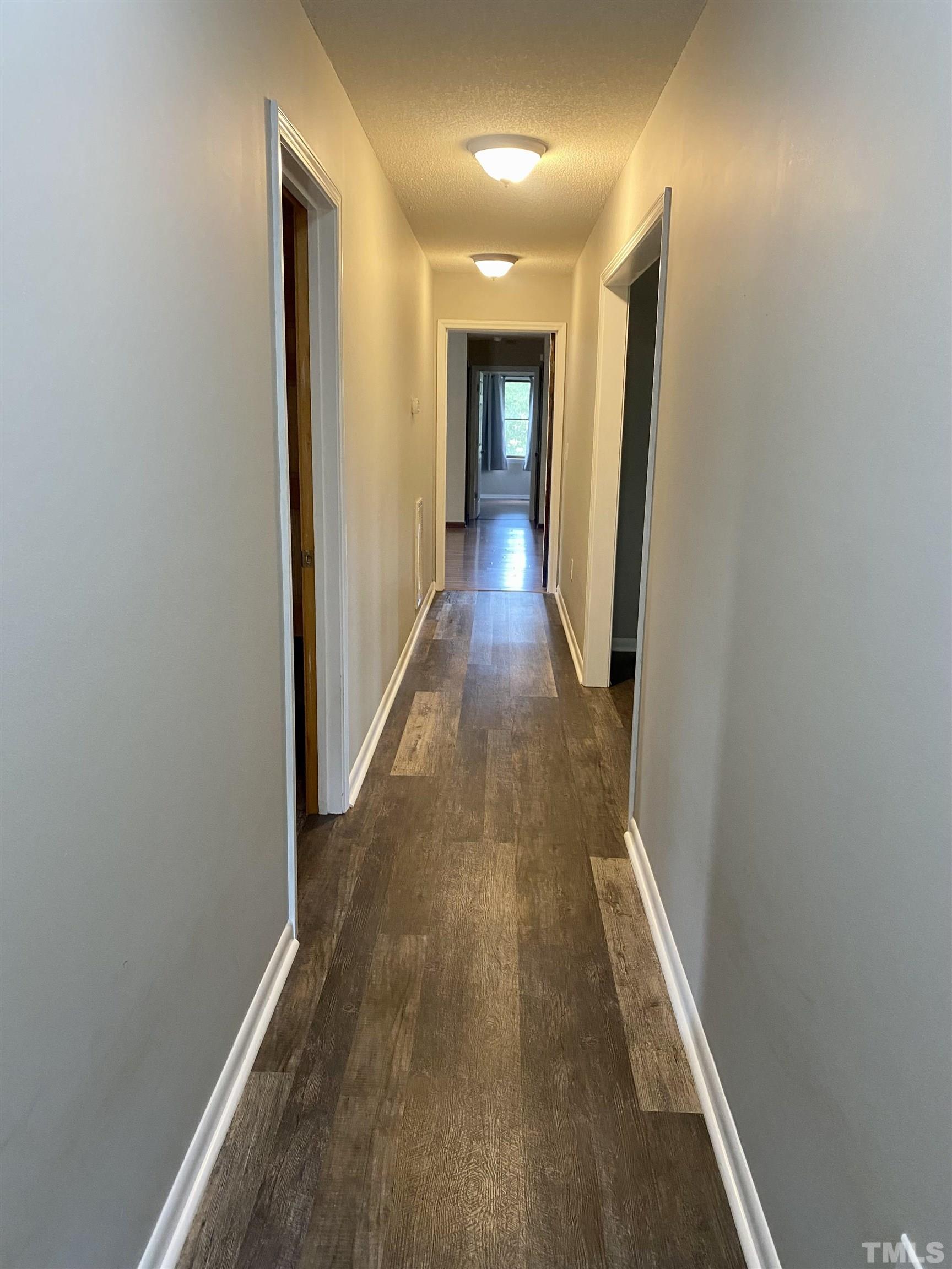 1887 Burnside Road Oxford, NC 27565 - Photo 17 of 42 a view of a hallway with wooden floor