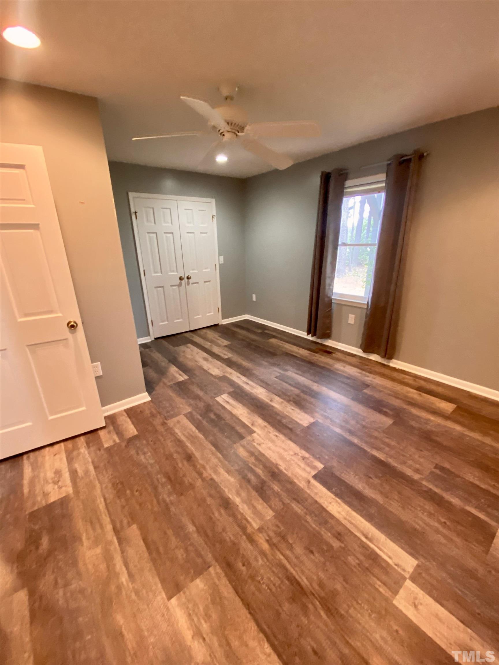 1887 Burnside Road Oxford, NC 27565 - Photo 19 of 42 a view of an empty room with window and wooden floor