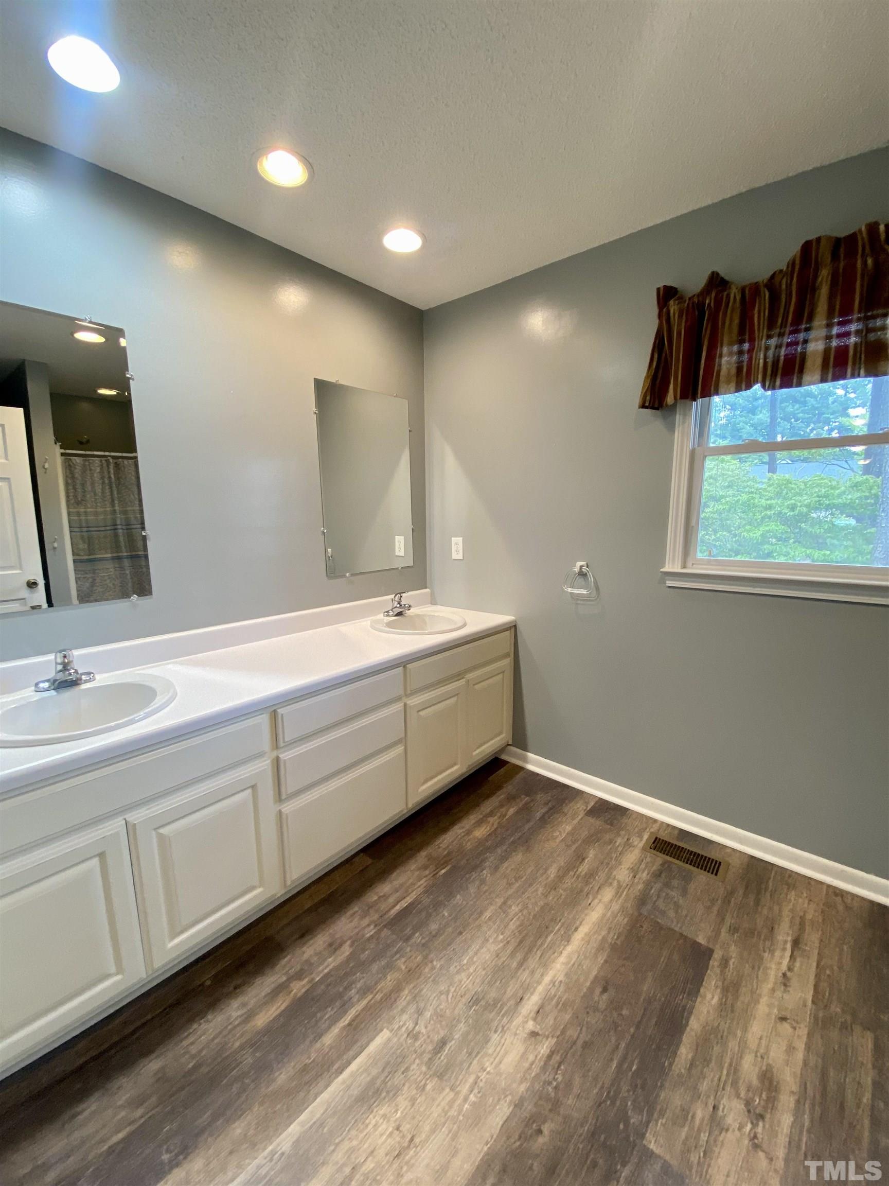 1887 Burnside Road Oxford, NC 27565 - Photo 20 of 42 a bathroom with a double vanity sink and a mirror