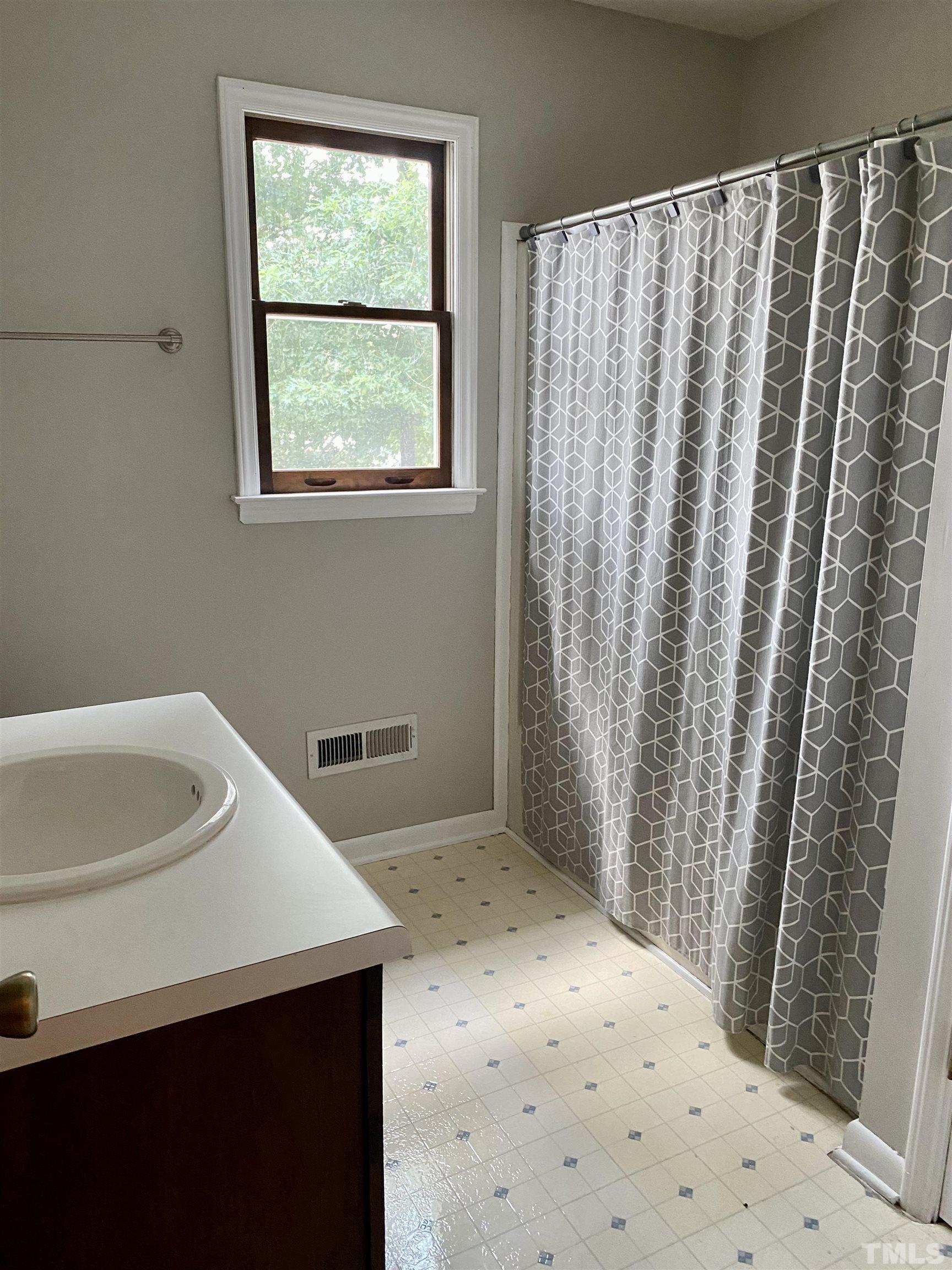 1887 Burnside Road Oxford, NC 27565 - Photo 23 of 42 a bathroom with a sink a toilet and shower