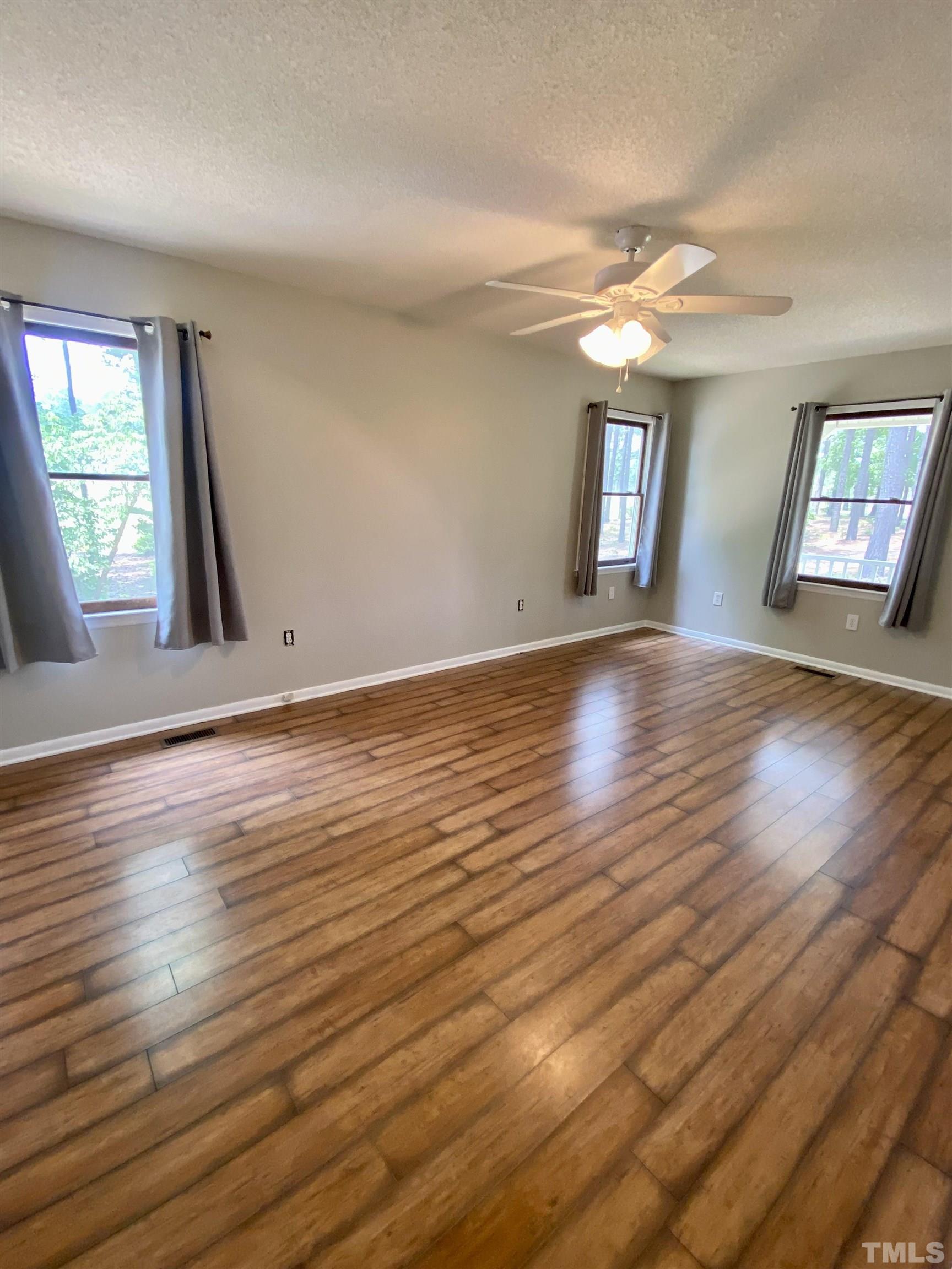 1887 Burnside Road Oxford, NC 27565 - Photo 24 of 42 a view of an empty room with wooden floor and a window