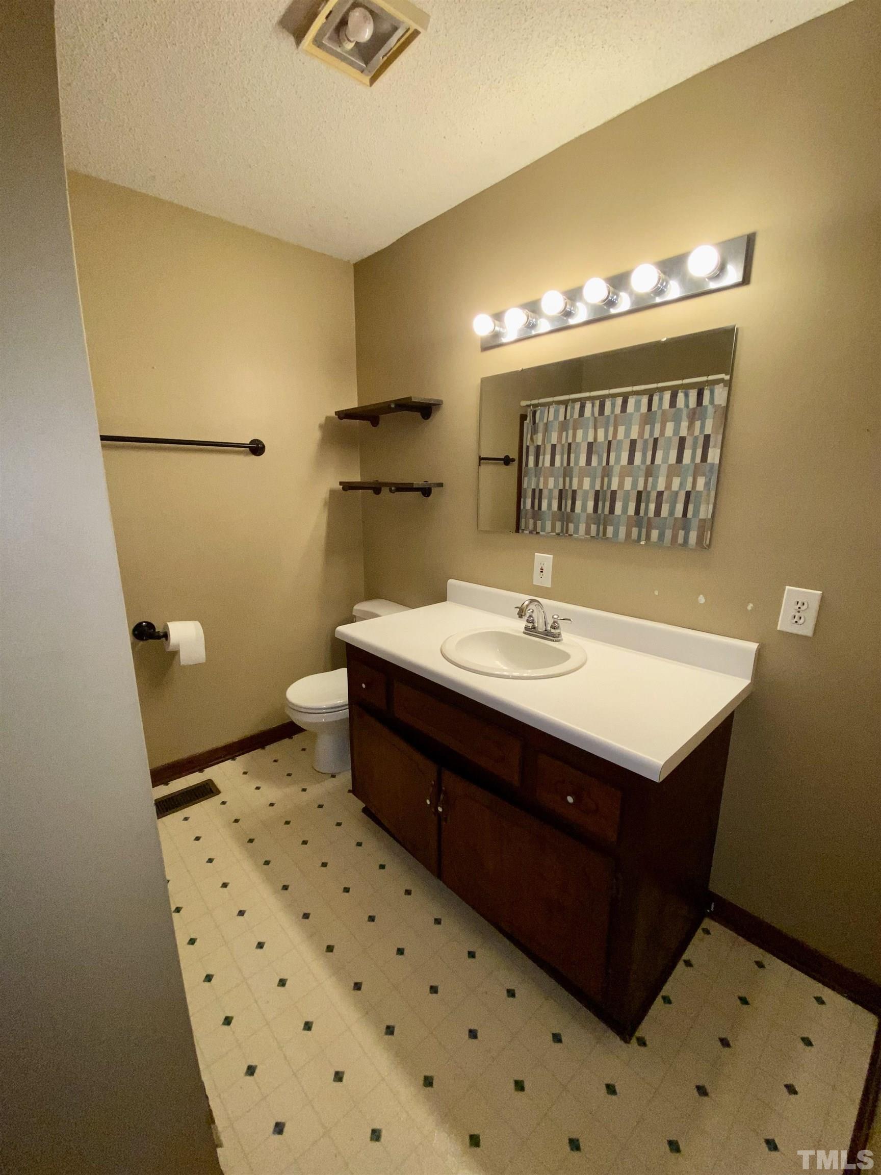 1887 Burnside Road Oxford, NC 27565 - Photo 27 of 42 a bathroom with a sink and a mirror