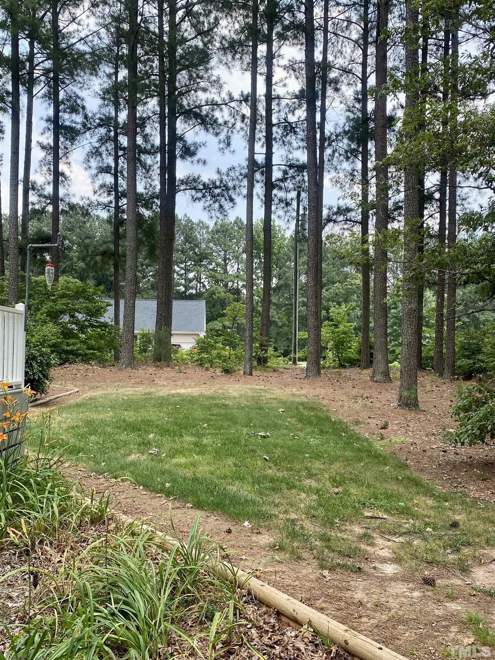 1887 Burnside Road Oxford, NC 27565 - Photo 30 of 42 a backyard of a house with lots of green space and fountain