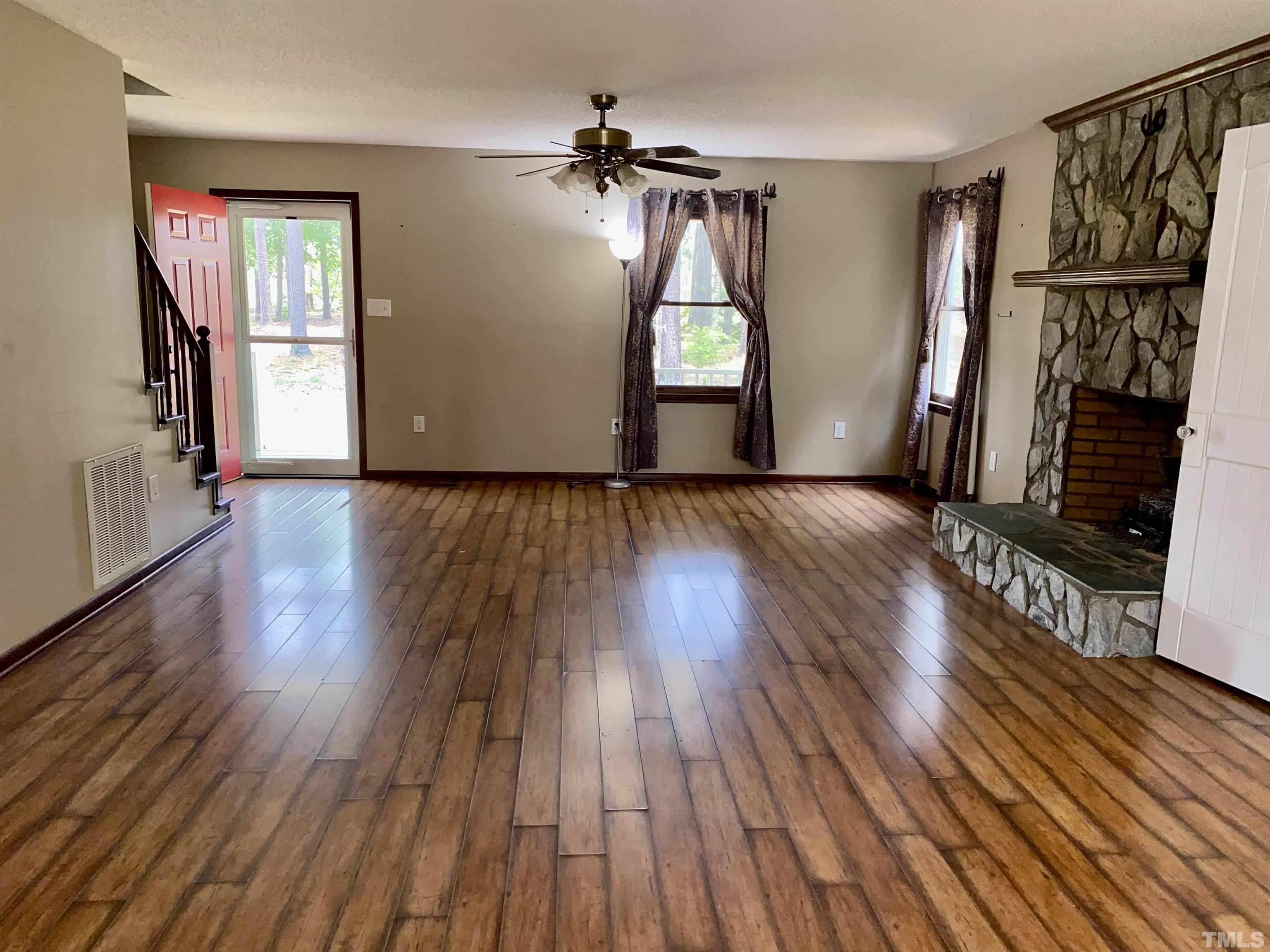 1887 Burnside Road Oxford, NC 27565 - Photo 4 of 42 a view of empty room with wooden floor and fan