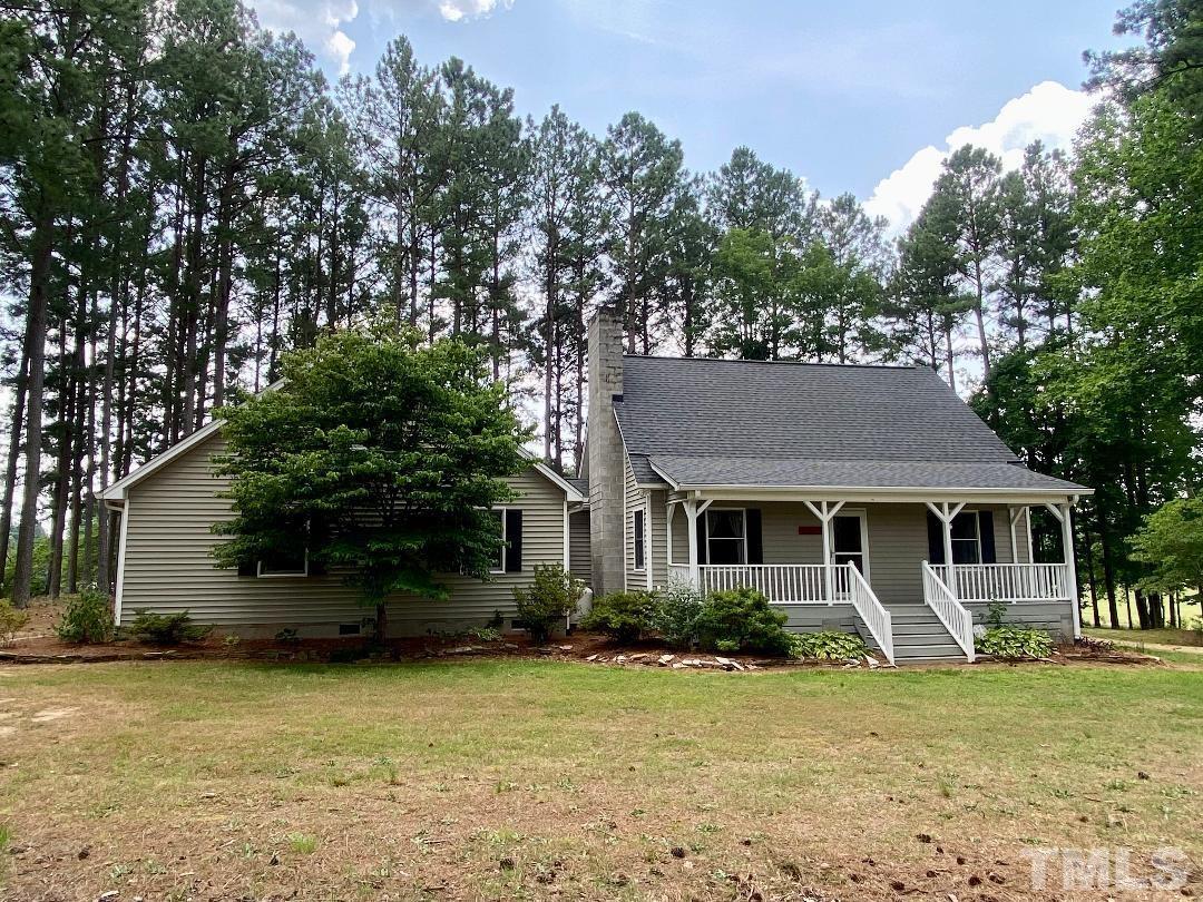 1887 Burnside Road Oxford, NC 27565 - Photo 41 of 42 a front view of a house with a yard and garage