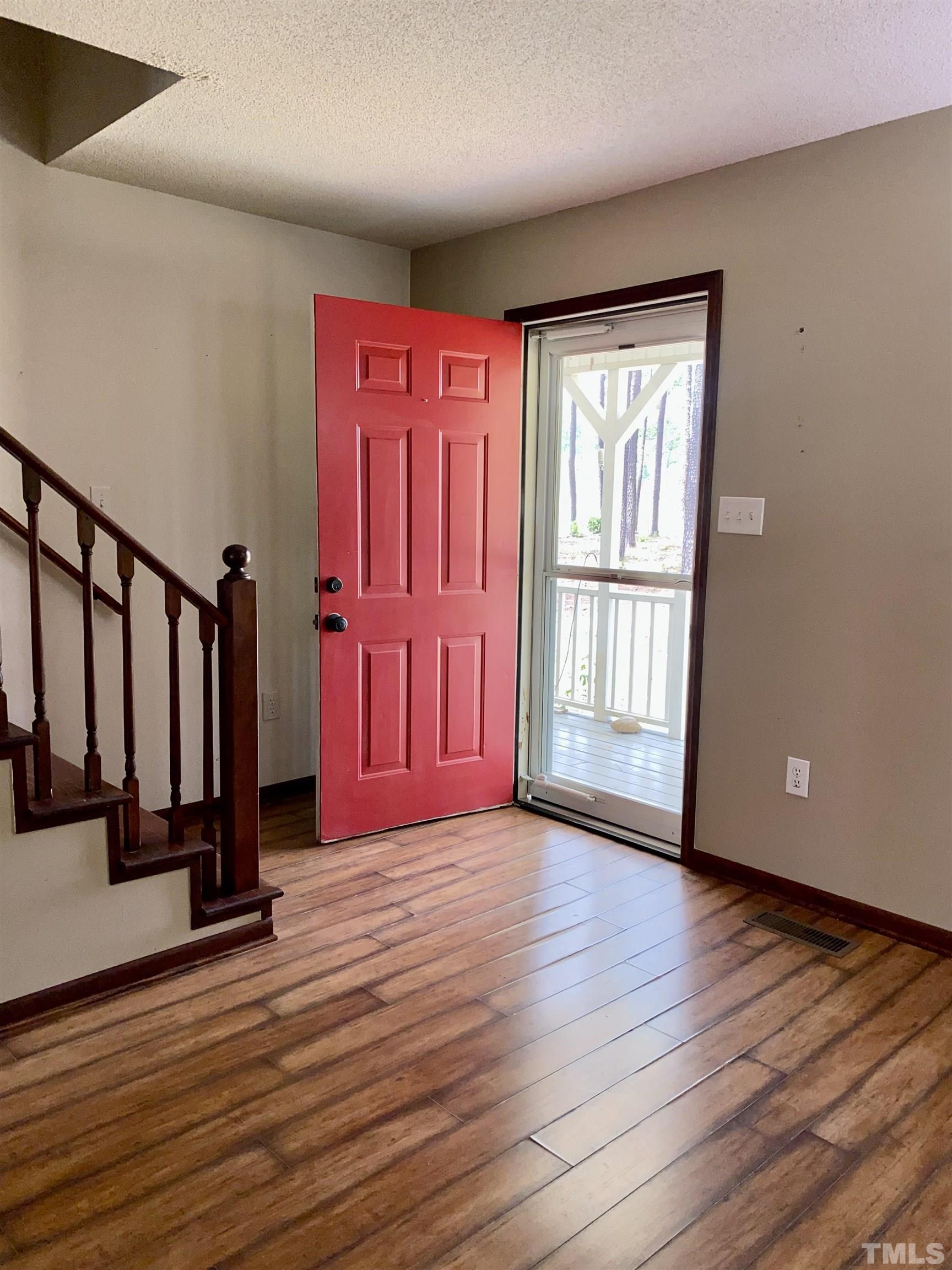 1887 Burnside Road Oxford, NC 27565 - Photo 6 of 42 a view of empty room with wooden floor and fan