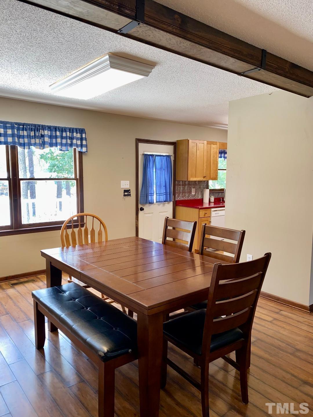 1887 Burnside Road Oxford, NC 27565 - Photo 9 of 42 a view of a dining room with furniture window and wooden floor