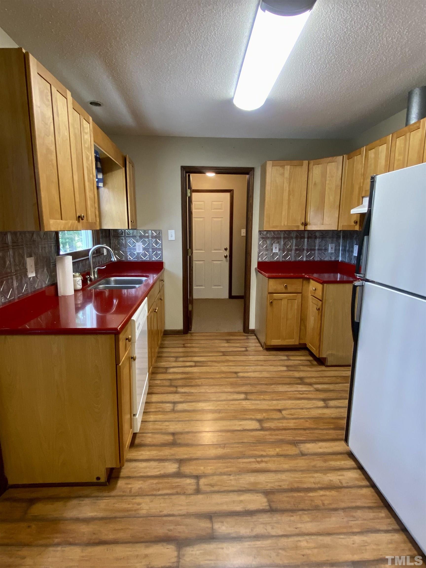 1887 Burnside Road Oxford, NC 27565 - Photo 10 of 42 a kitchen with sink refrigerator and window