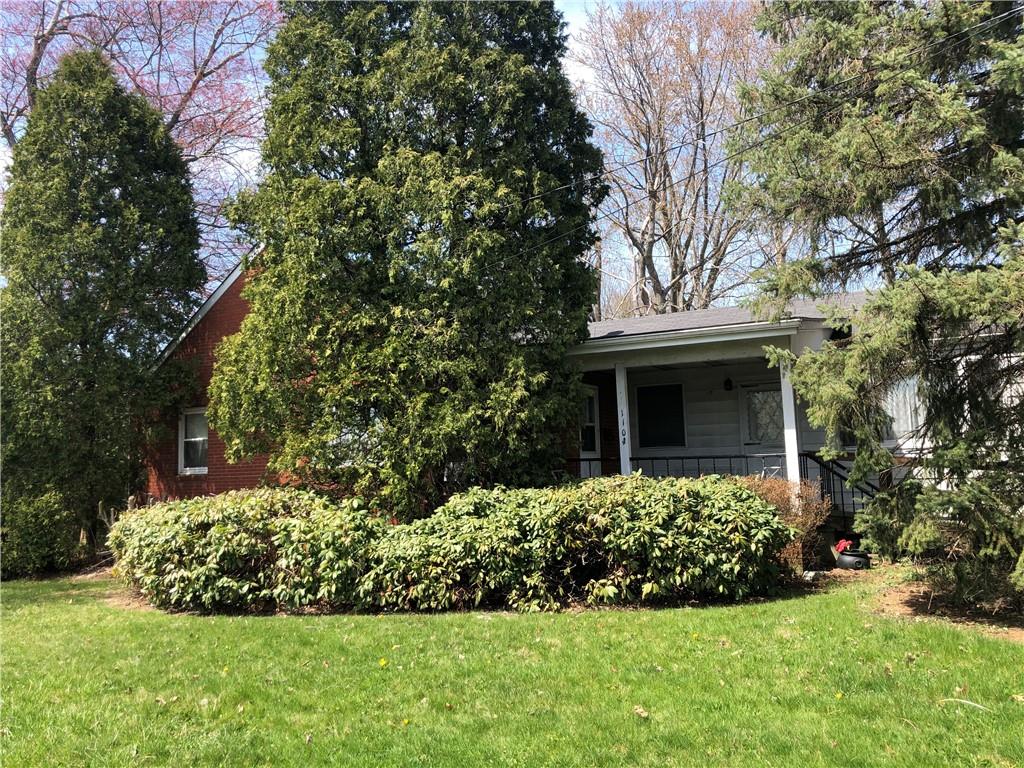 a view of house with a yard
