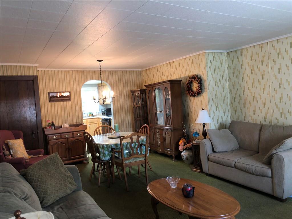 1104 13th Street Conway, PA 15027 - Photo 12 of 31 a living room with furniture and a chandelier