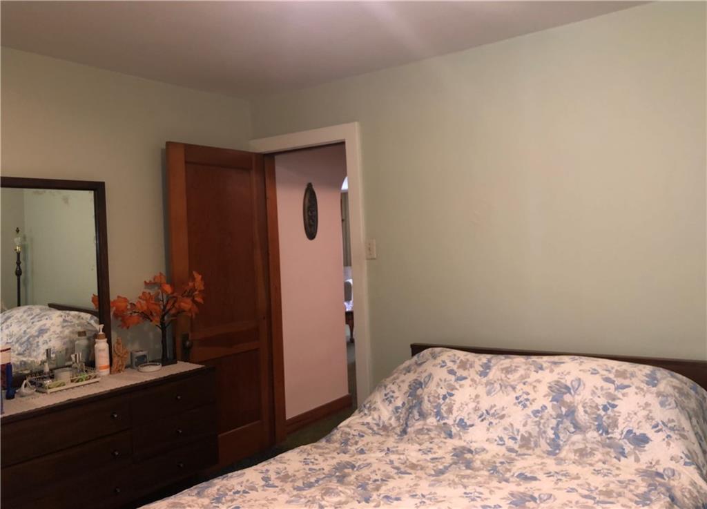 1104 13th Street Conway, PA 15027 - Photo 17 of 31 a bedroom with a bed and a dresser in it