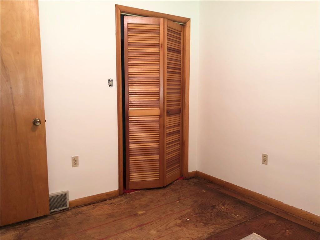 1104 13th Street Conway, PA 15027 - Photo 29 of 31 an empty room with wooden floor and windows