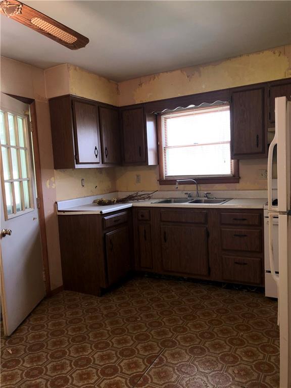 1104 13th Street Conway, PA 15027 - Photo 30 of 31 a kitchen with a sink a stove and cabinets