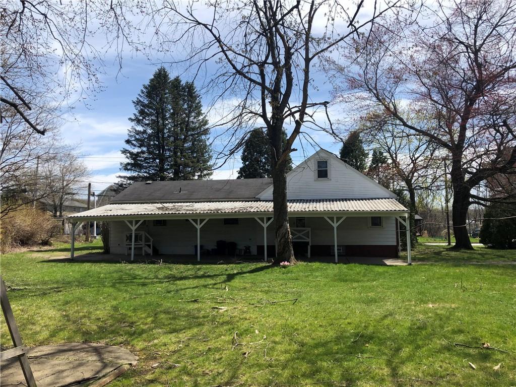 1104 13th Street Conway, PA 15027 - Photo 4 of 31 a front view of a house with a garden and trees