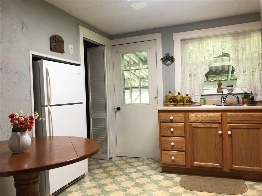 1104 13th Street Conway, PA 15027 - Photo 10 of 31 a kitchen with stainless steel appliances granite countertop a sink refrigerator and window