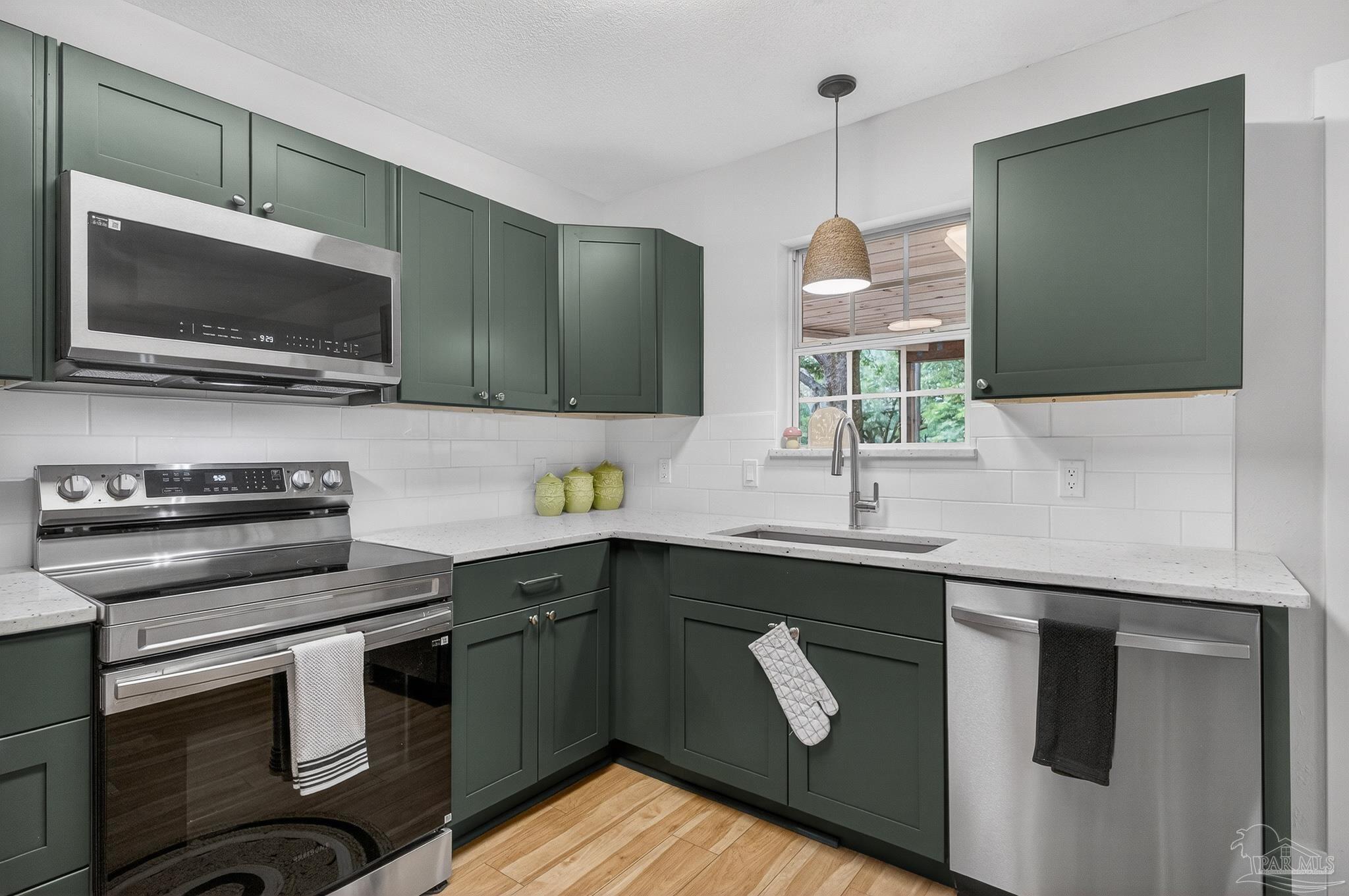 4771 Carl Booker Road Milton, FL 32583 - Photo 19 of 65 a kitchen with a sink and a microwave