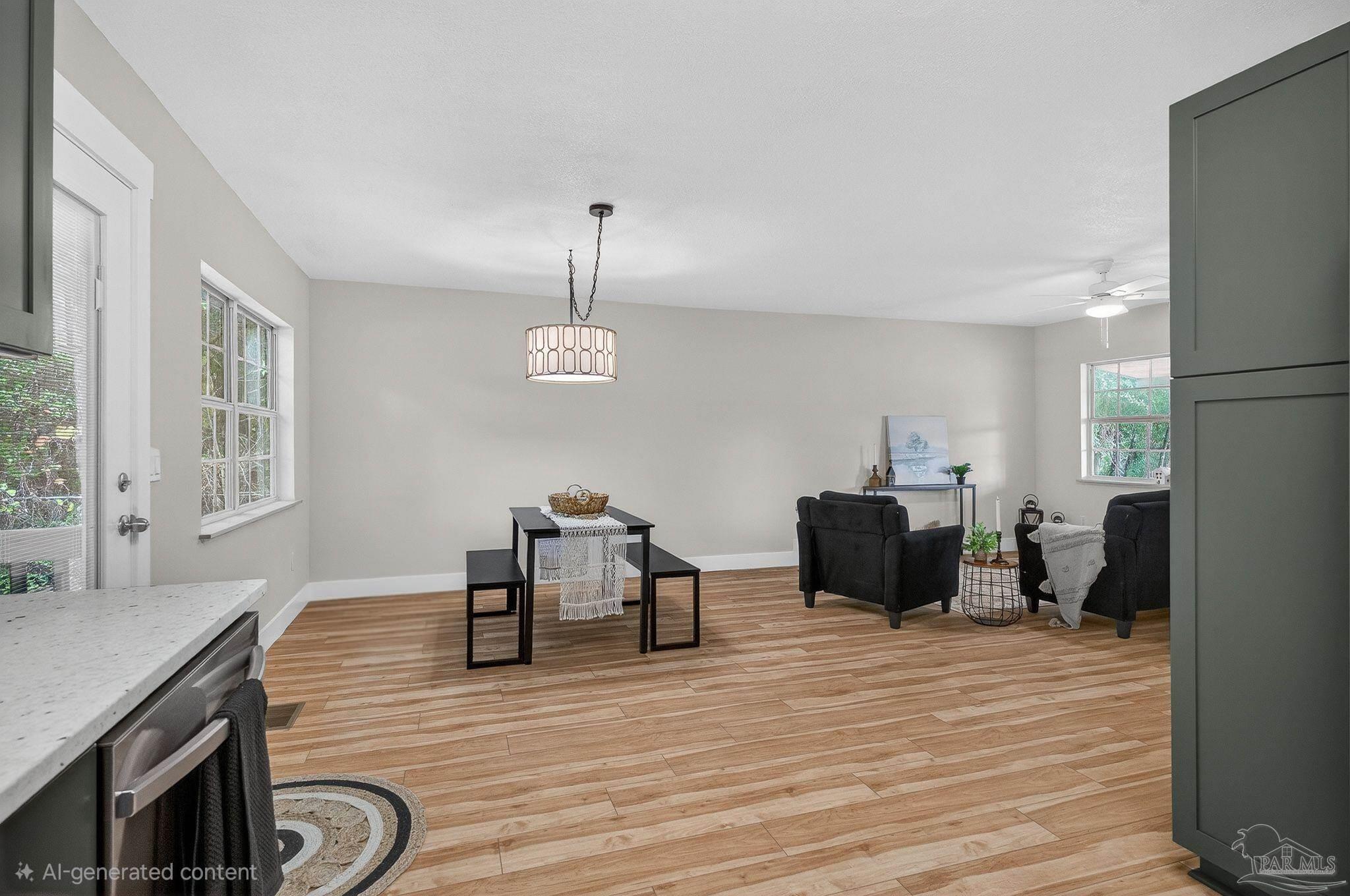 4771 Carl Booker Road Milton, FL 32583 - Photo 22 of 65 a living room with furniture kitchen view and a wooden floor
