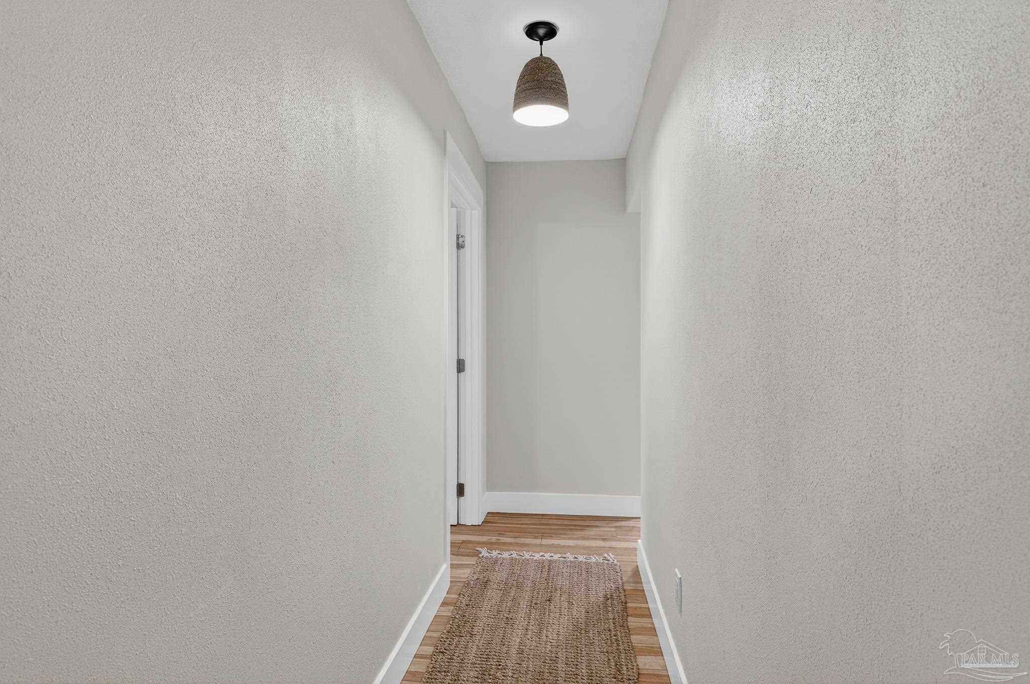 4771 Carl Booker Road Milton, FL 32583 - Photo 24 of 65 a view of a room with wooden floor and white walls