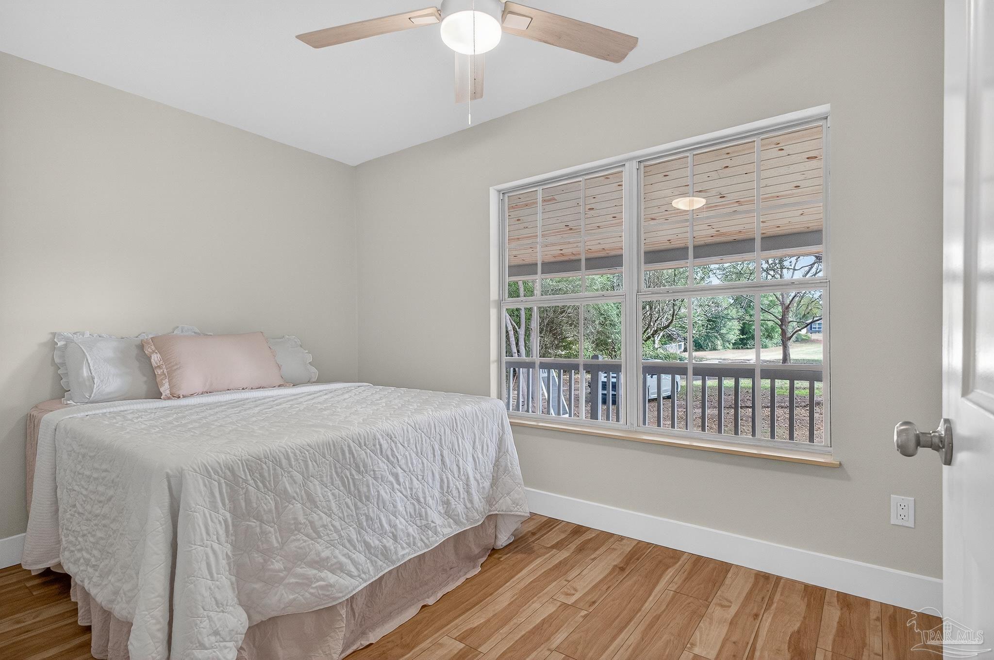 4771 Carl Booker Road Milton, FL 32583 - Photo 25 of 65 a bedroom with a large bed and a large window