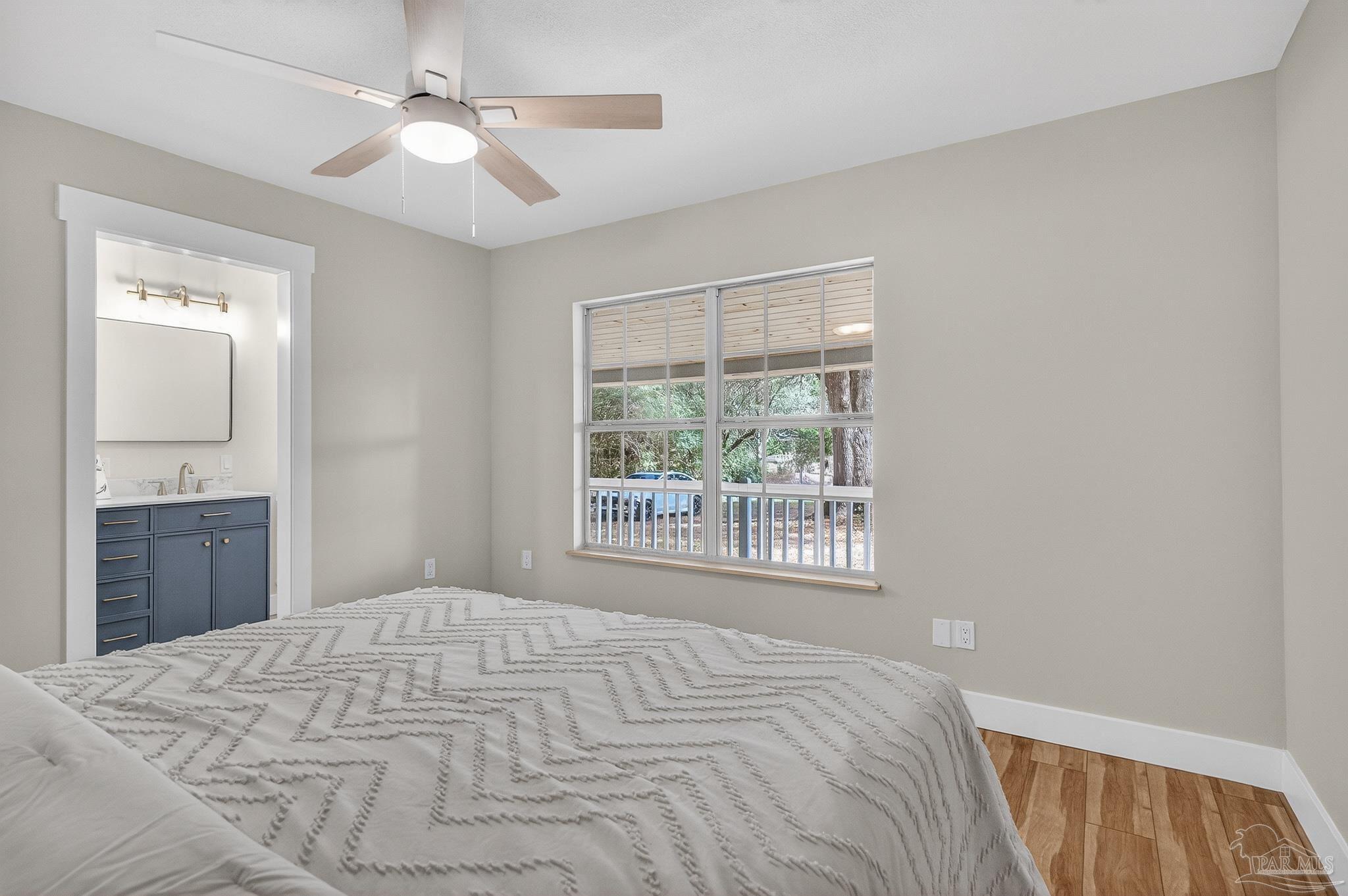 4771 Carl Booker Road Milton, FL 32583 - Photo 44 of 65 a bedroom with a large bed and a window