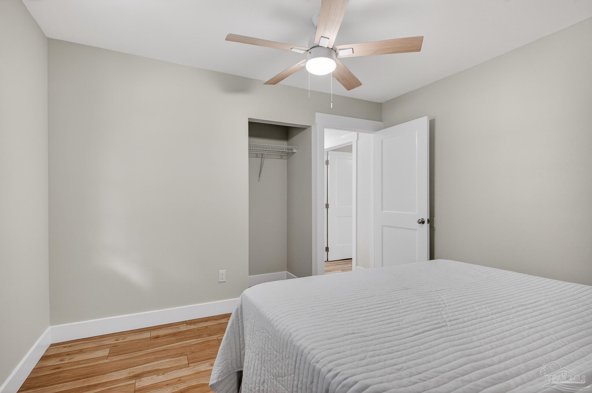 4771 Carl Booker Road Milton, FL 32583 - Photo 49 of 65 a bedroom with a bed and a chandelier