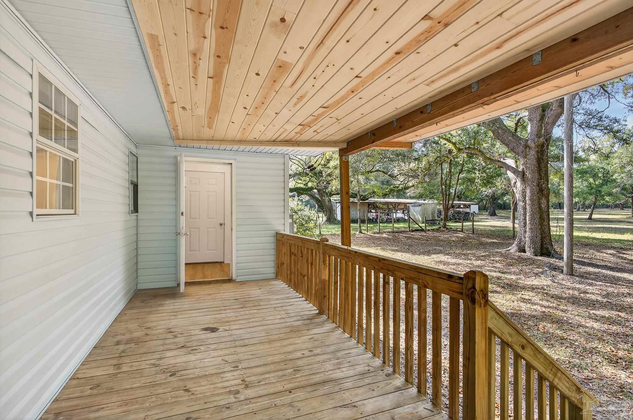 4771 Carl Booker Road Milton, FL 32583 - Photo 55 of 65 a view of a porch with wooden floor and outdoor space