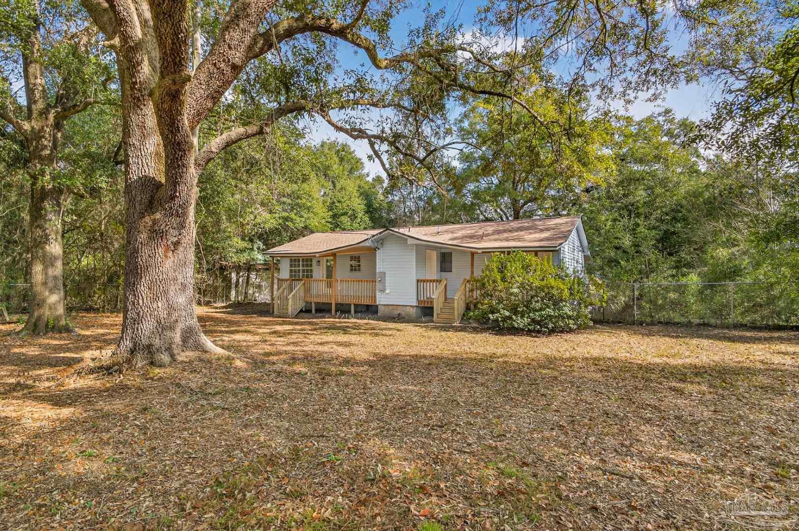 4771 Carl Booker Road Milton, FL 32583 - Photo 58 of 65 a front view of a house with a garden